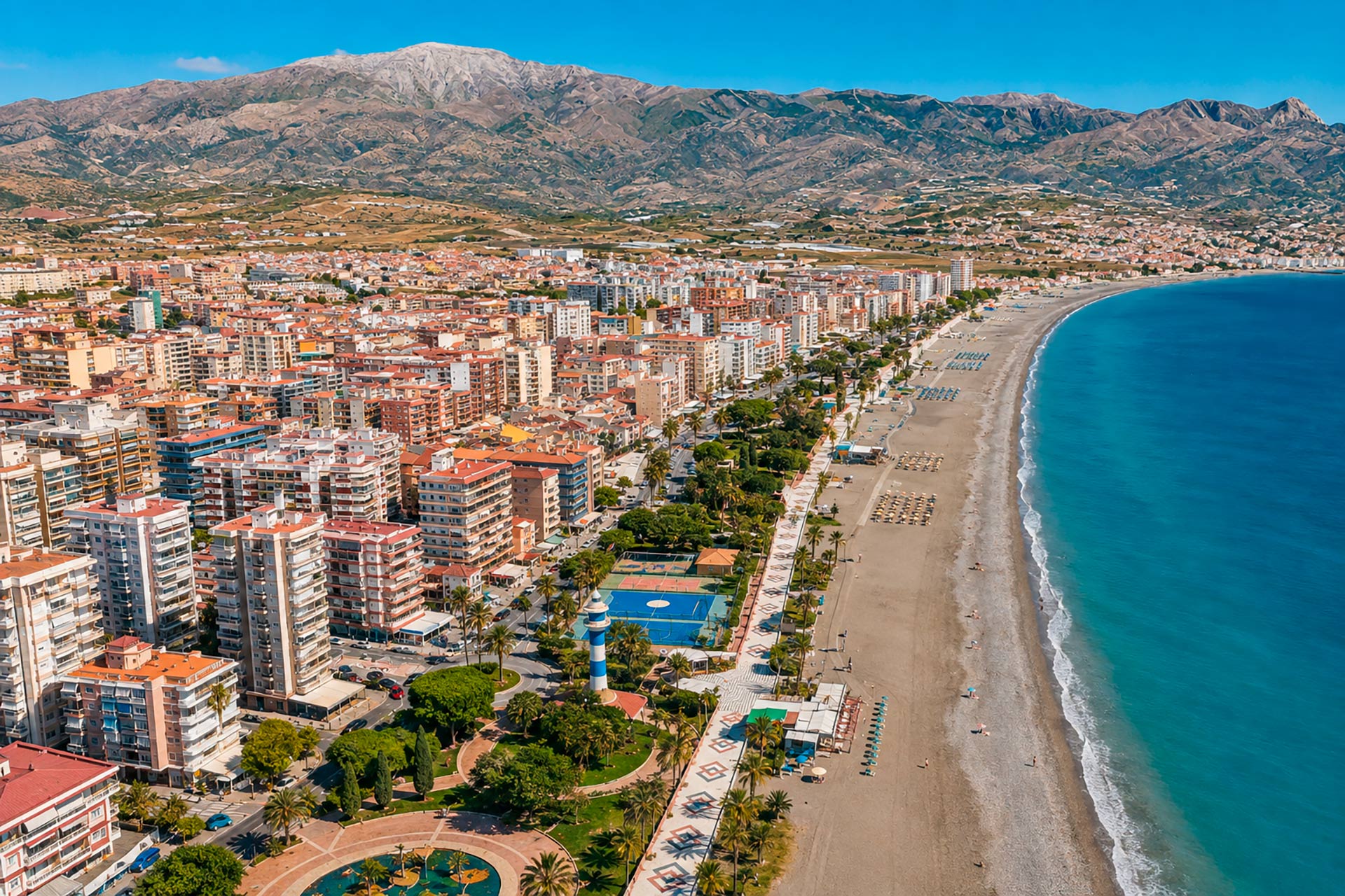 Aerial view of Torre del Mar beachfront, palm-lined promenade and urban centre with the Axarquía mountains in the background