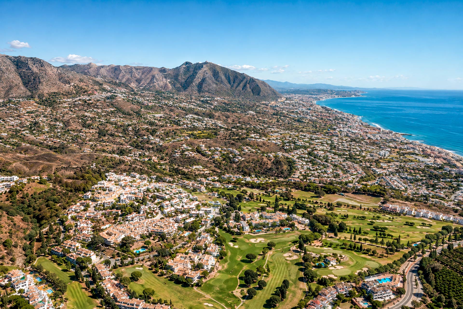 Aerial view of Mijas, Málaga, with mountains, golf courses, residential areas and the Mediterranean coast